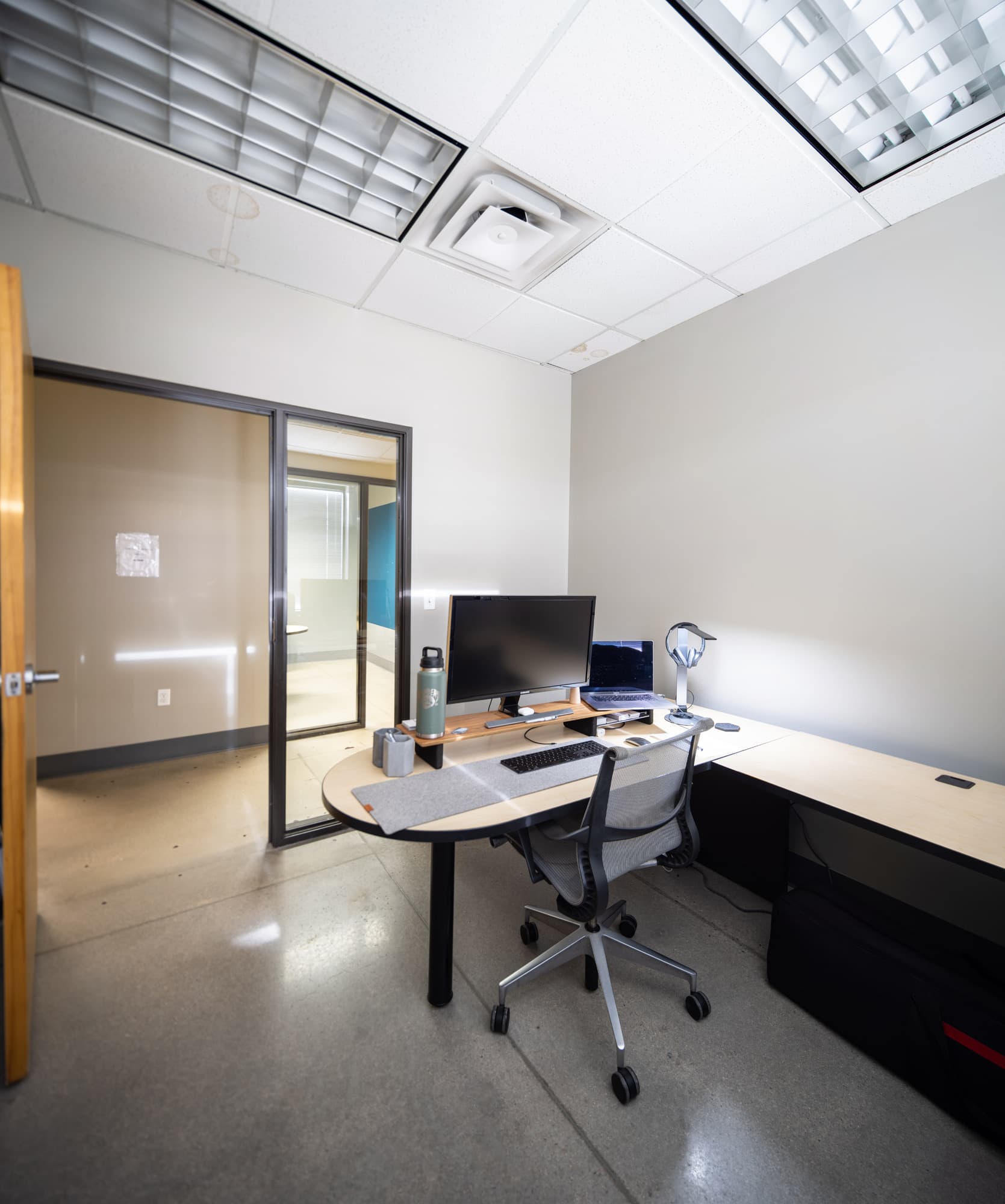 Office 4 — desk, monitor, and glass door